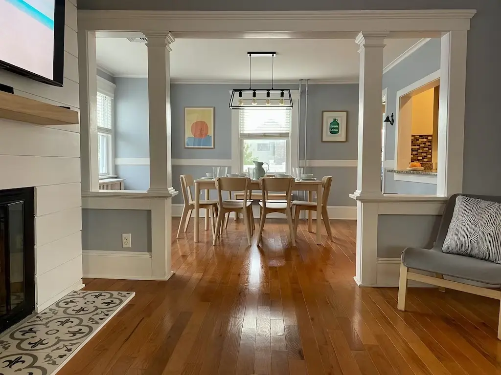 Dining room with hardwood floors and modern light fixture